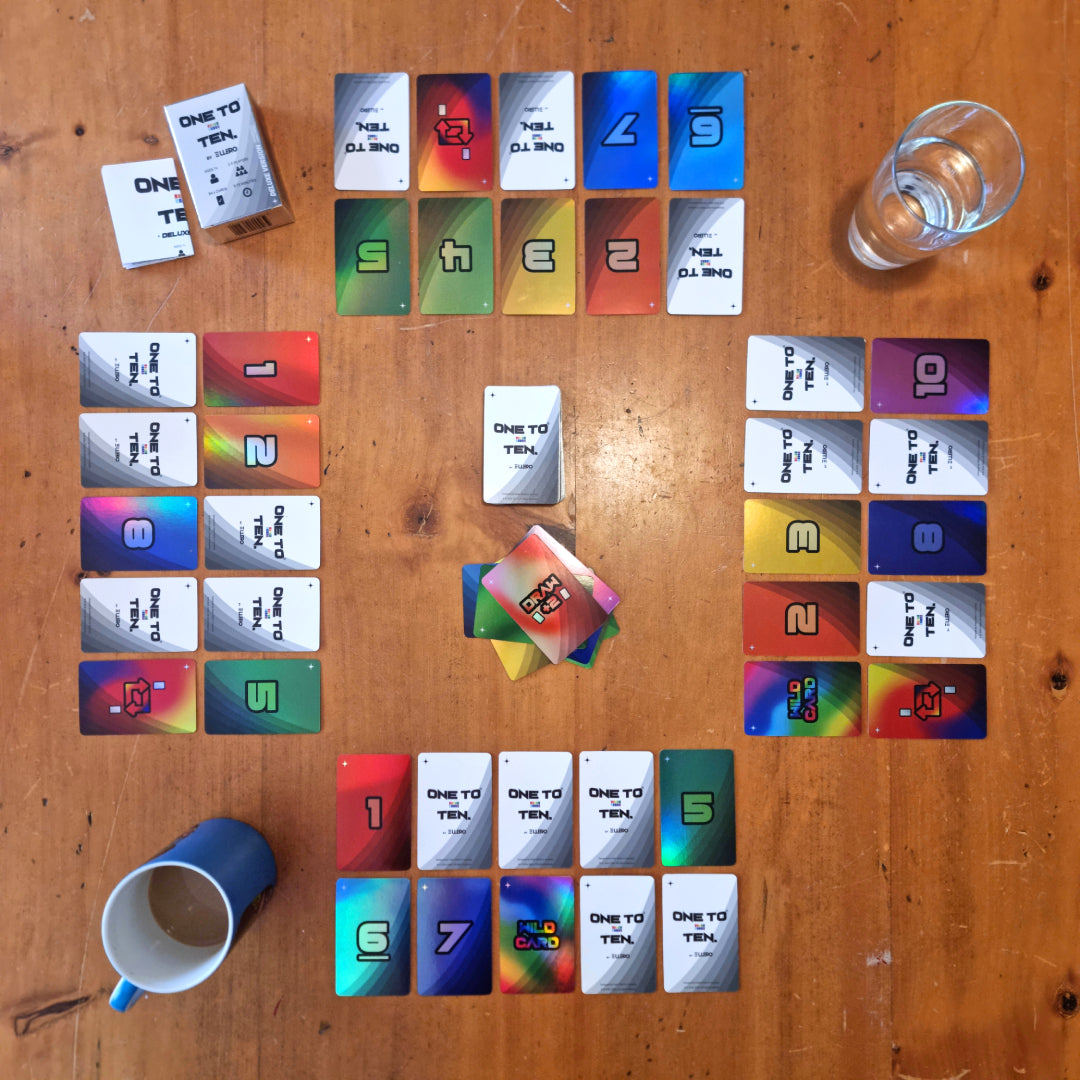 The deluxe version of ONE TO TEN the card game. Rainbow cards on a table.